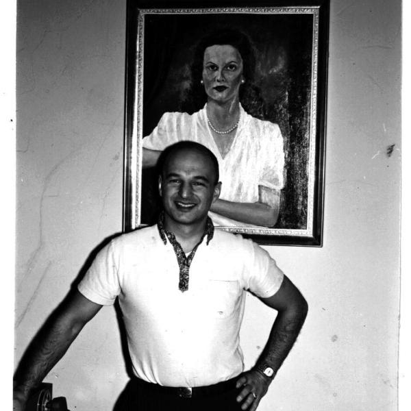 Herb Bridge with portrait of his wife Shirley behind him in 1960. The portrait was created by the artist Neale Ordayne. This portrait was on display in the Traditional Gallery of Frederick & Nelson in 1949. Image Courtesy Bridge Family. 