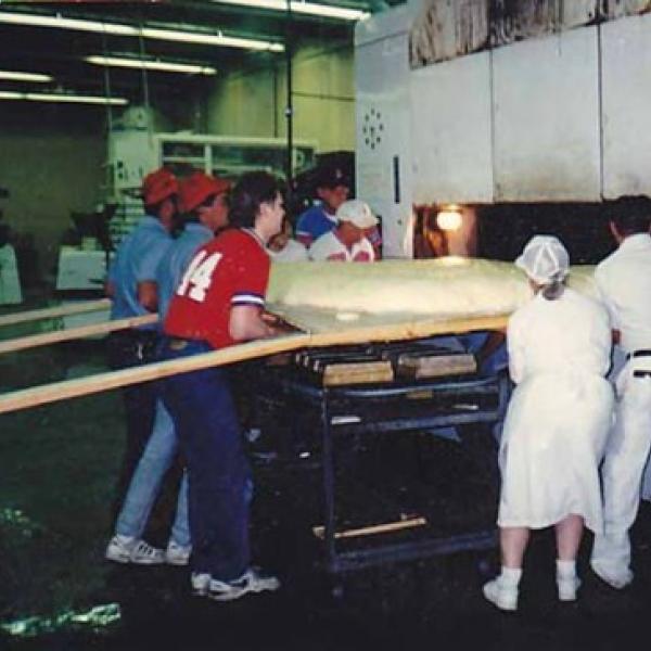 Brenner Brothers bakers easing world's largest bagel into oven, Bellevue, July 1994