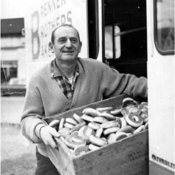 Charlie Brenner holding a box of bagels next to a Brenner Brothers Bakery delivery truck