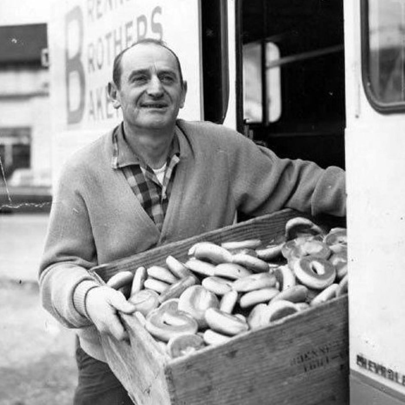 Charlie Brenner holding box of bagels next to Brenner Brothers Bakery delivery truck, Seattle