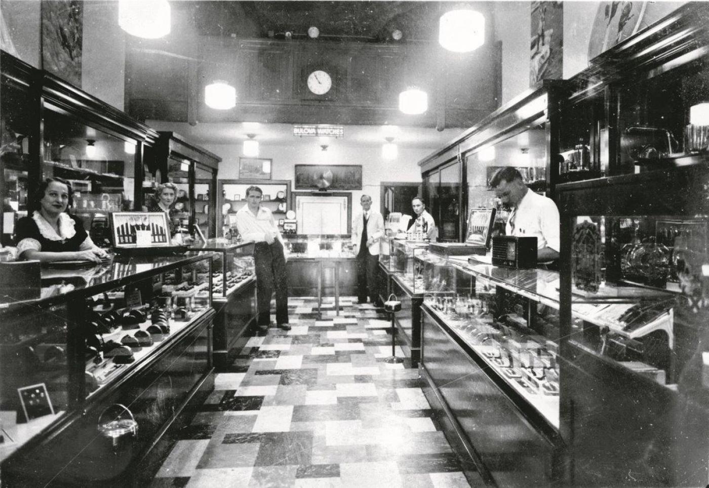 Ben Bridge Jeweler interior in 1939. Herb's mother Sally Bridge is on the far left, Leo Bridge, far left, leaning; watchmaker Phil Blanks; Ben Bridge's cousin Max Flaks; and another watchmaker, Otis Cook, near right.