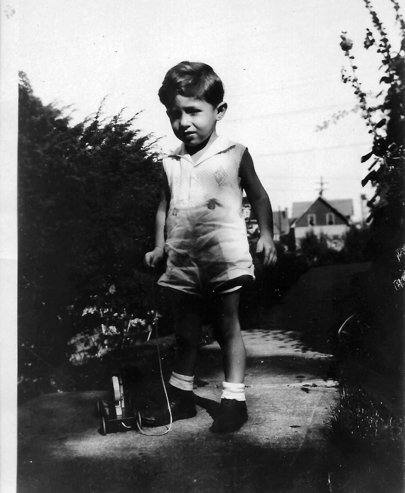 Joe Greengard in the yard with a pull toy