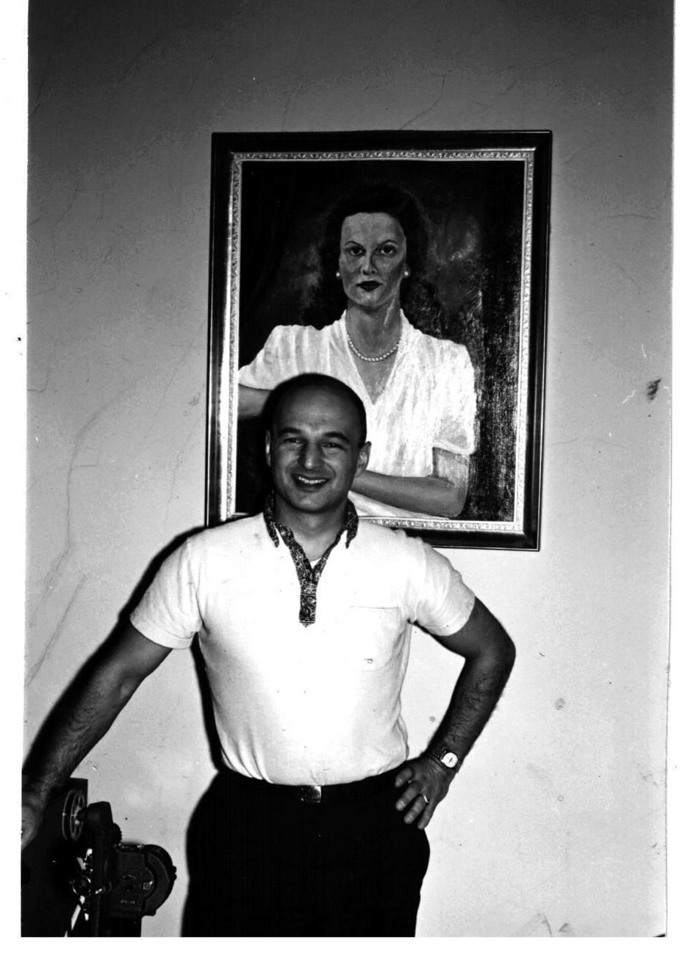 Herb Bridge with portrait of his wife Shirley behind him in 1960. The portrait was created by the artist Neale Ordayne. This portrait was on display in the Traditional Gallery of Frederick & Nelson in 1949. Image Courtesy Bridge Family. 