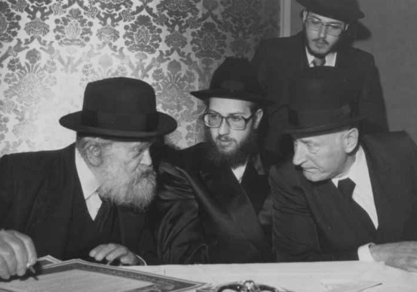Cantor Chaim Gottlieb (far right), his sons, Ephraim and Moshe, and Grand Rabbi Yakov Kamenetsky(left) confer during the signing of the ketubah (Jewish marriage contract) at Gottlieb's son's wedding, Seattle, 1979