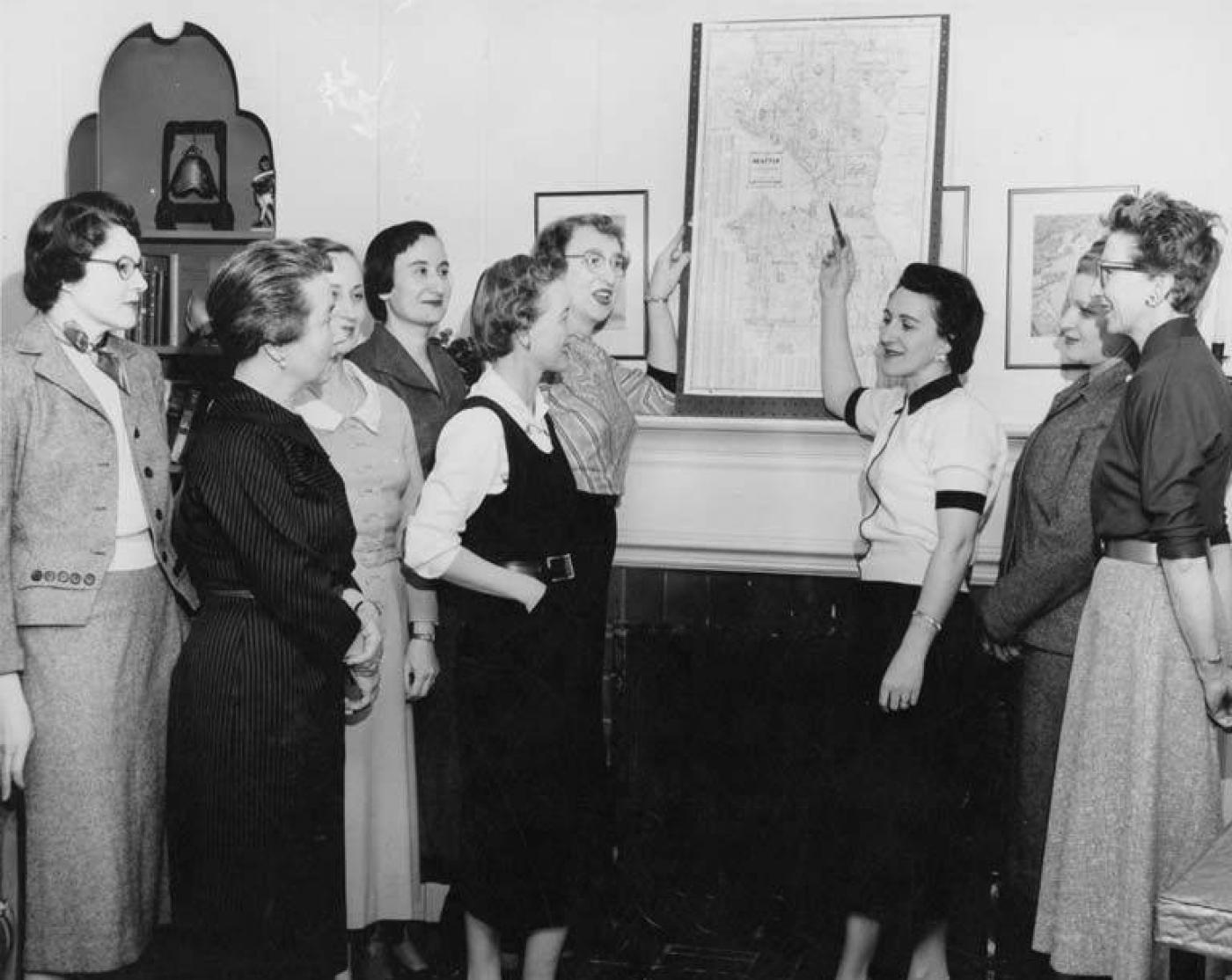 Leaders of the Women's Division of the Federated Jewish Fund pointing to a Seattle map, Seattle, 1955