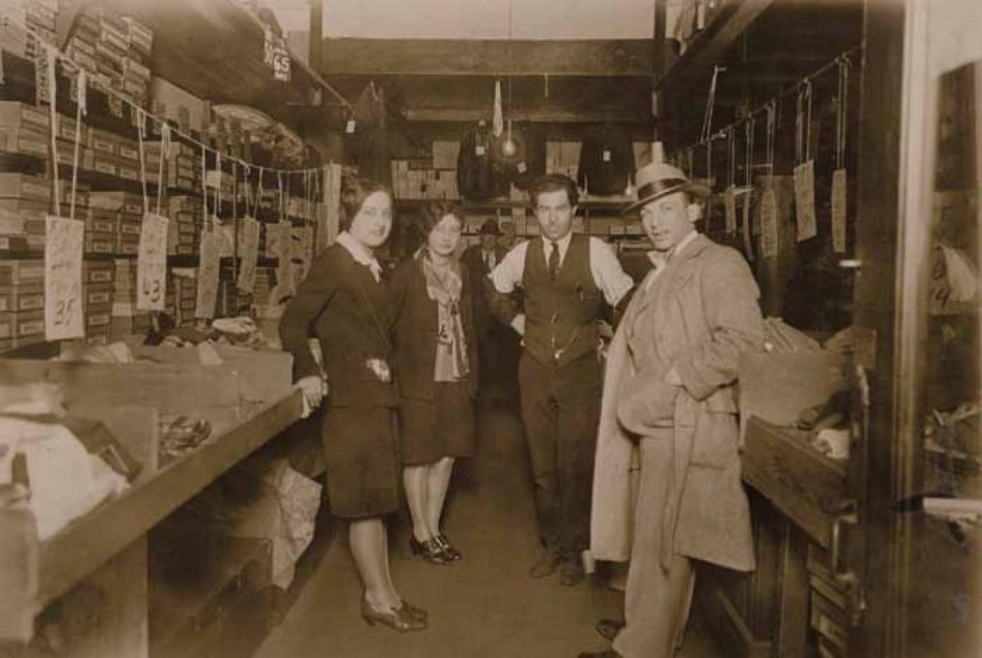 Abraham Steinberg (center) with Dolores Cohen (left) and unidentified man and woman at Steinberg's clothing store at 515 S. Jackson St., Seattle, Washington, approximately 1920s.jpg