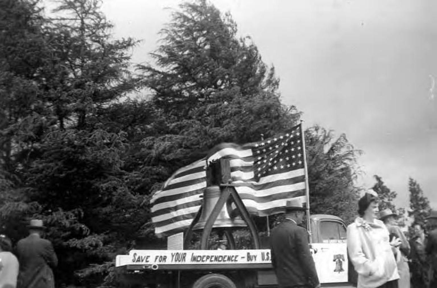 Truck decorated with Liberty Bell replica and American flag for Veterans Meeting and War Bond Drive, Seattle, Washington, probably between 1950 and 1953
