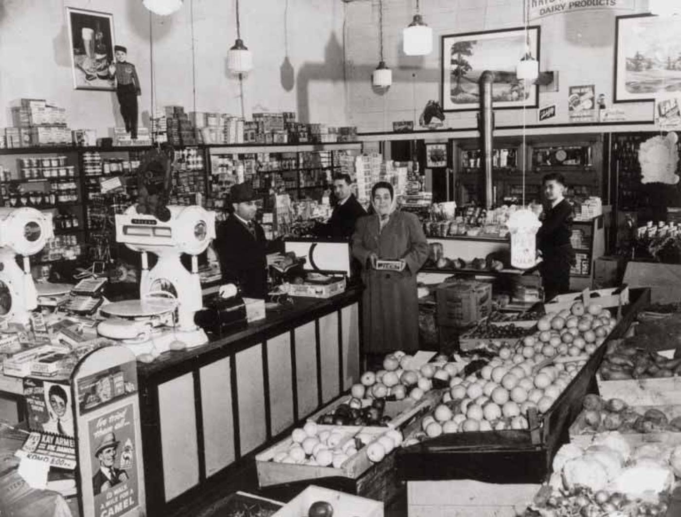 24th Ave. Market interior with (from left) owners Sam and Isaac Maimon, Rachel Habib and Al Azose, 2401 Yesler Way, Seattle, 1941