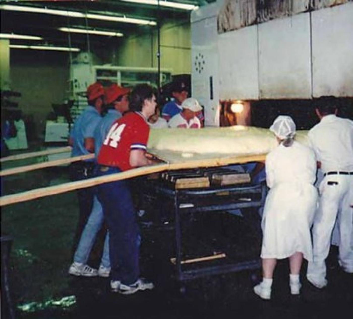 Brenner Brothers bakers easing world's largest bagel into oven, Bellevue, July 1994