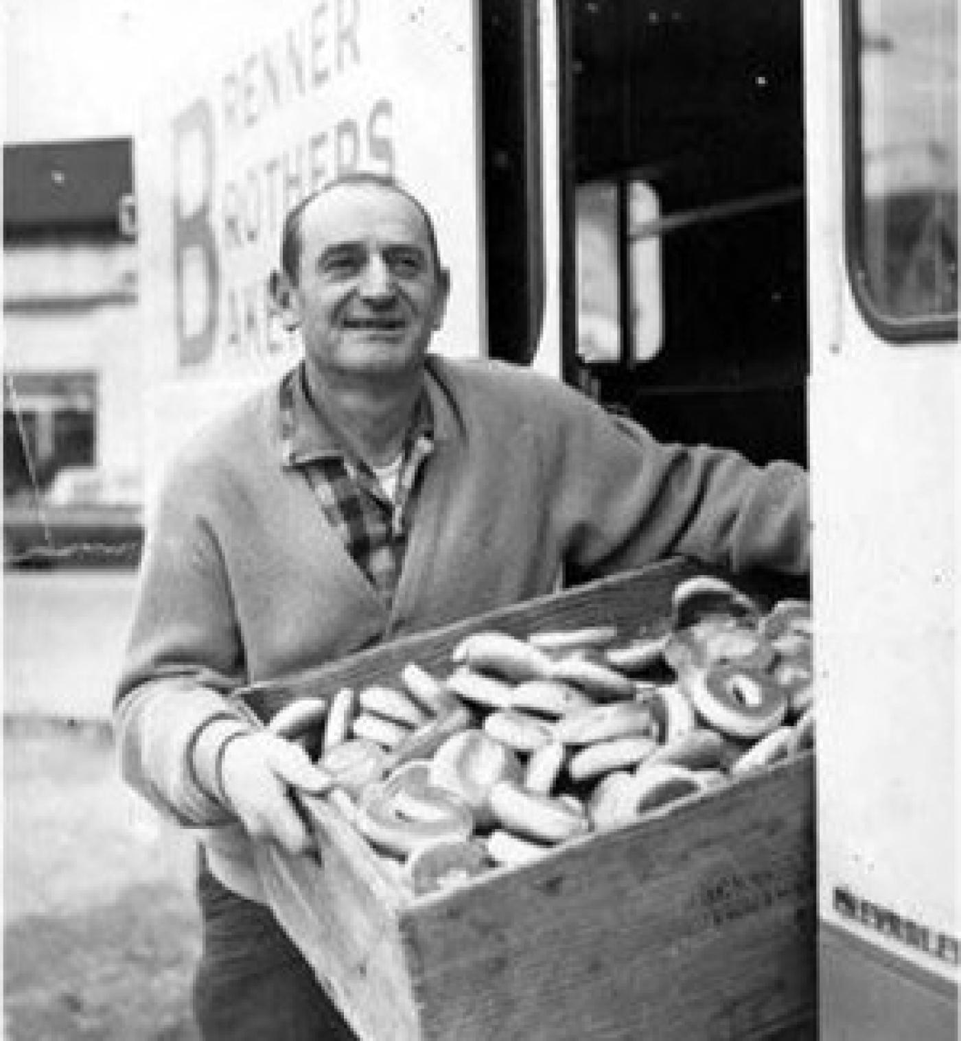 Charlie Brenner holding a box of bagels next to a Brenner Brothers Bakery delivery truck
