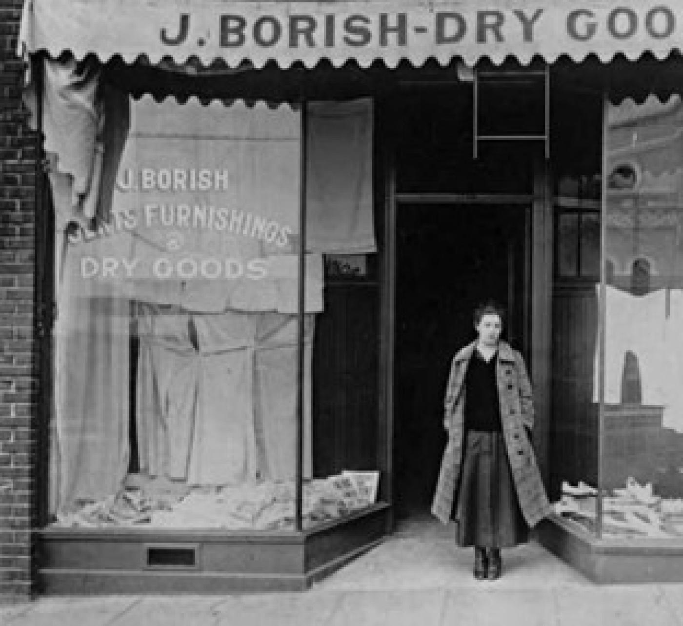 Anna Borish Lustig standing in front of Borish Dry Goods store, 1702 Yesler Way, Seattle, Washington, 1916