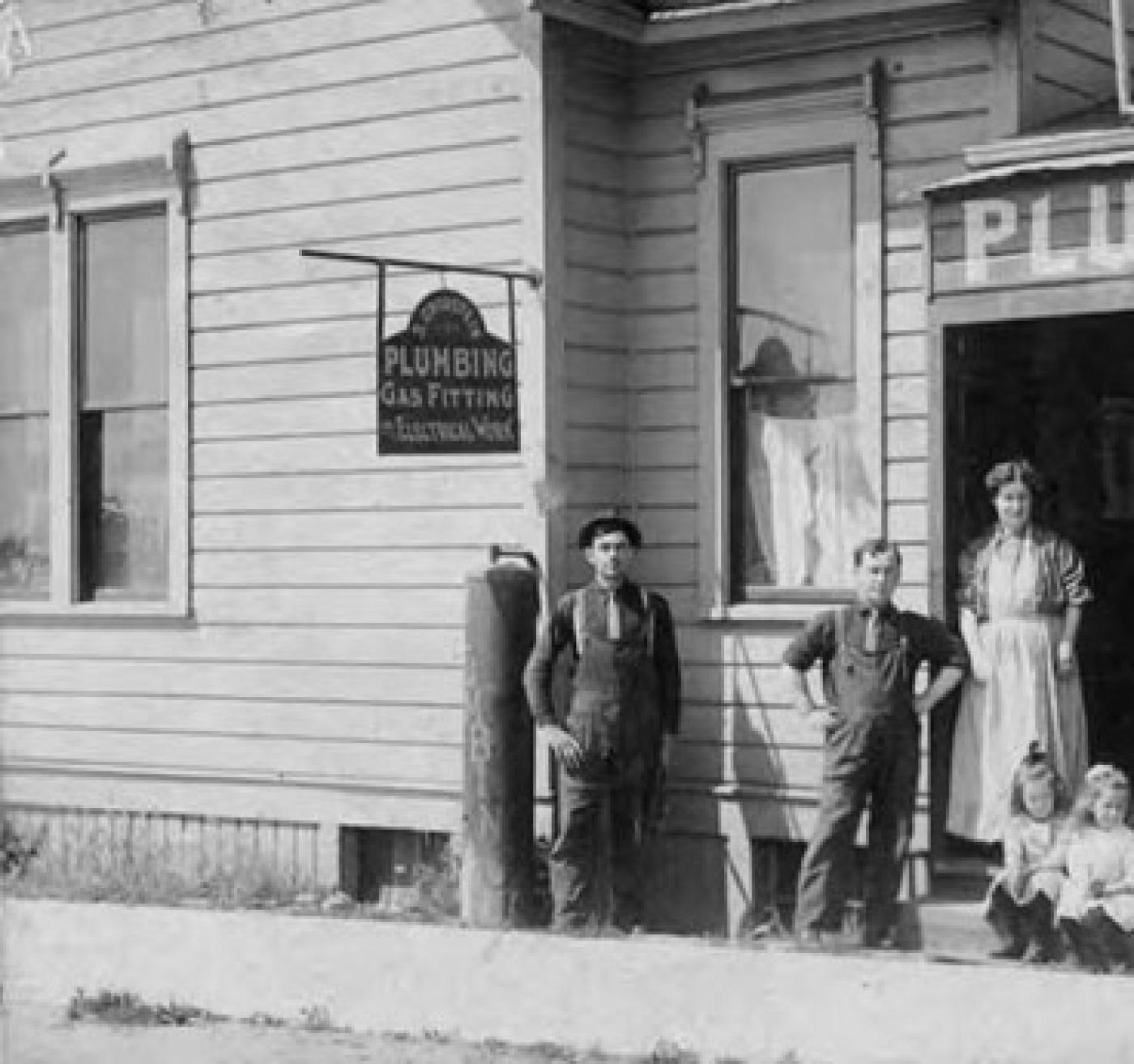Exterior of S. Grodstein Plumbing store at 14th Ave. and Yesler Way, Seattle, owned by Samuel Grodstein, 1912 Store was also the family residence. Shown are: Bertha Grodstein, Eva Grodstein and Rose Grodstein