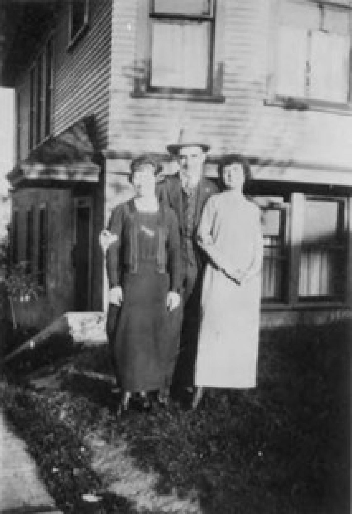 Group of people outside of Mosler apartments, 1217 Yesler Way, 1917. (Left to right) Rickles, Alec Malin, Freda Rickles (Malin).