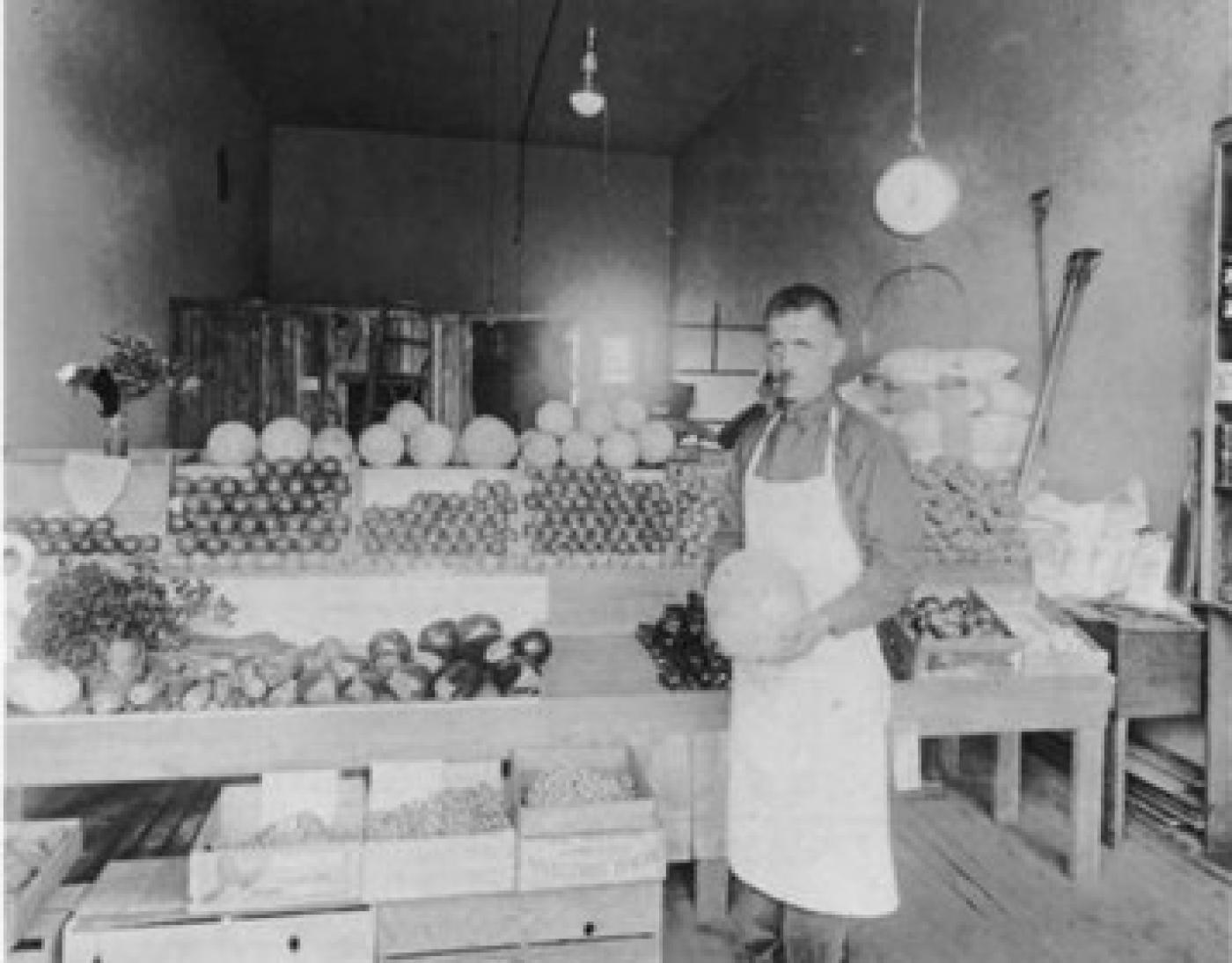 Madras Kirkor, proprietor of Kirkor's Grocery, 1621 Yesler Way, Seattle, ca. 1925-1929