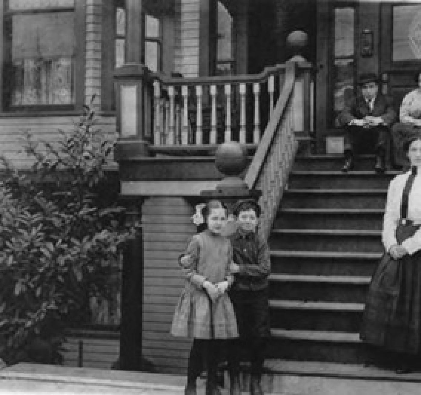 Mosler Apartments with people sitting, standing on steps, Seattle, ca. 1910s-1920s