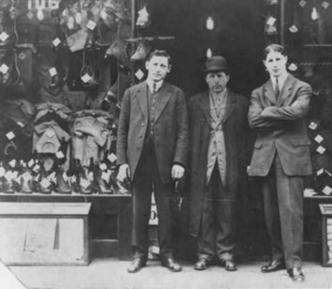Store owner Herman with Morris Buttnick, Jack Seidenverg and Ed Lund (L to R) in front of store, 106 S. Washington St., Seattle, Washington, ca. 1916-1918