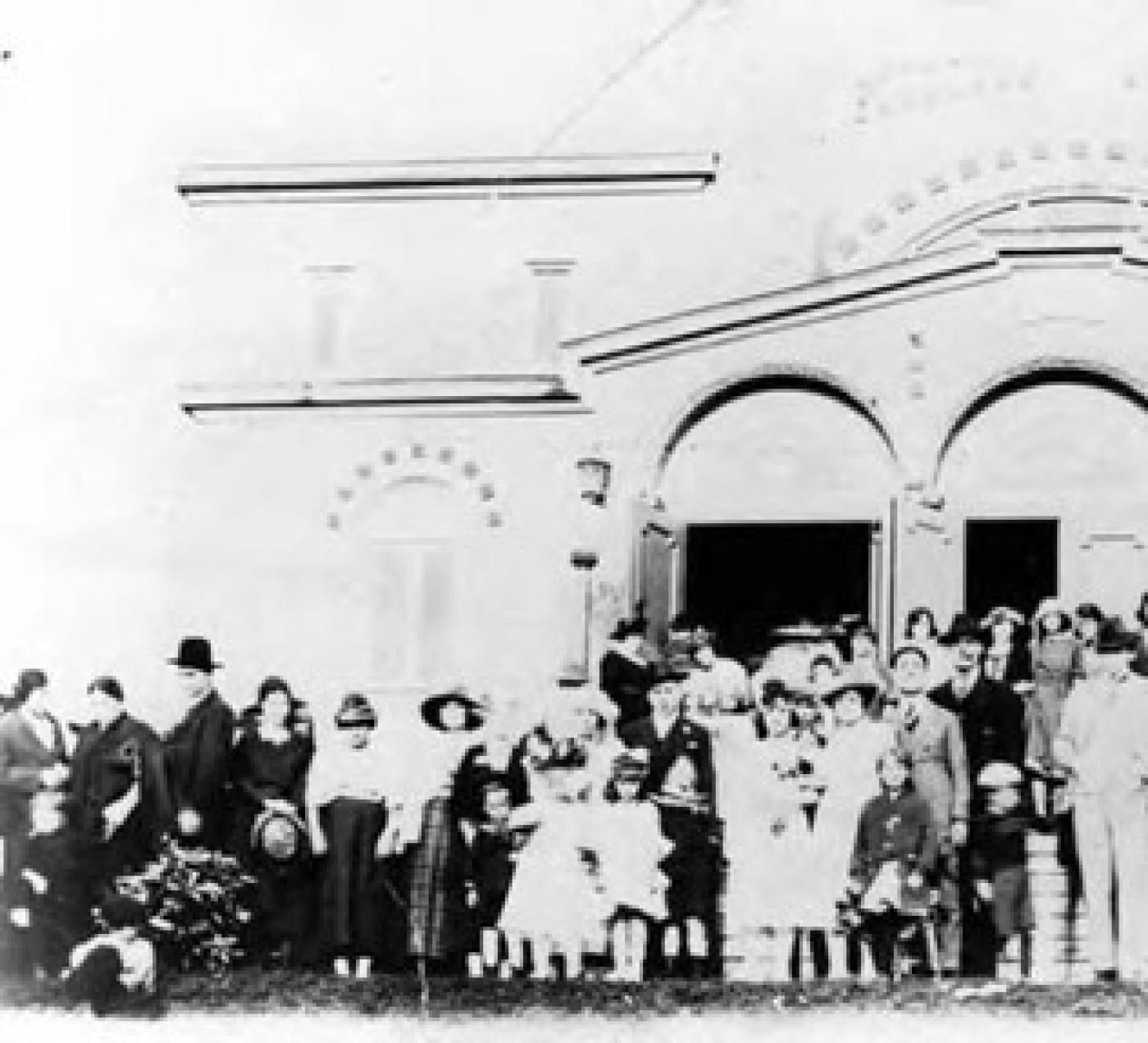 Wedding party of Morris and Sultana Cohen and guests outside of Ezra Bessaroth synagogue, 1921