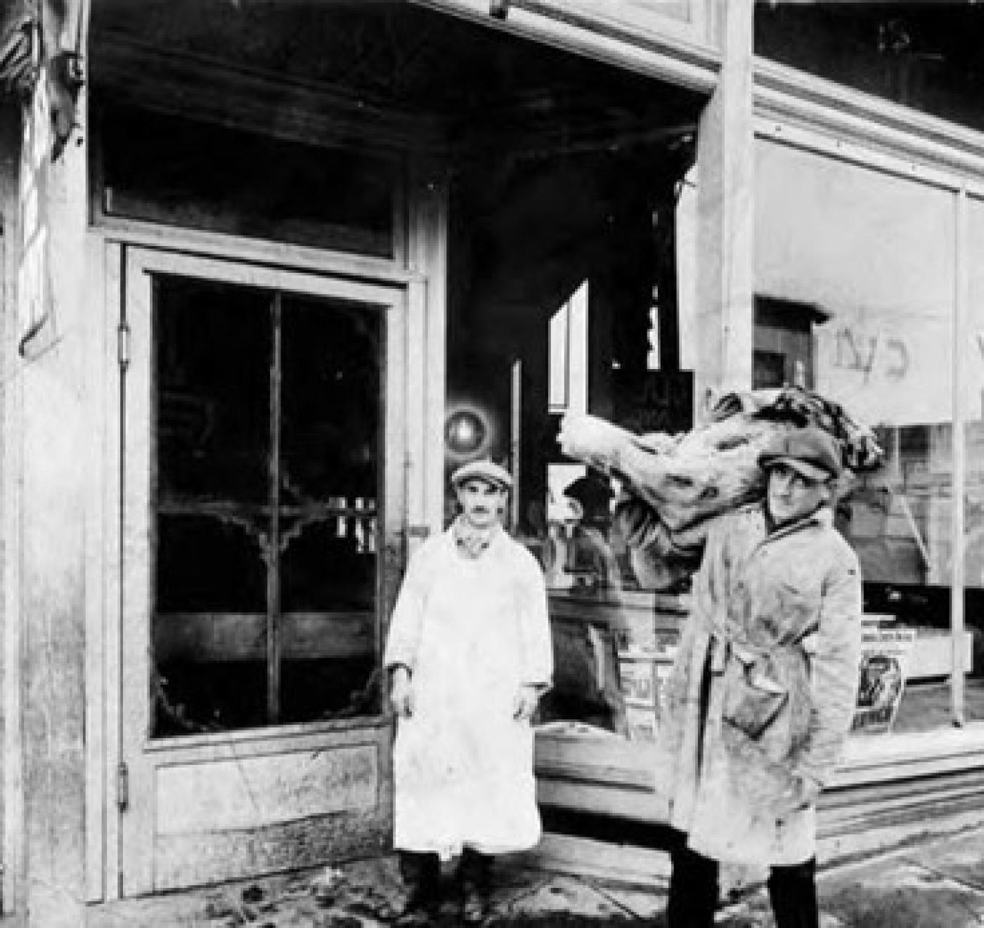 Ziegman's Market at 1718 Yesler Way, with Louis Ziegman (left) and possibly Mr. Woron (right) holding side of beef, Seattle, 1930