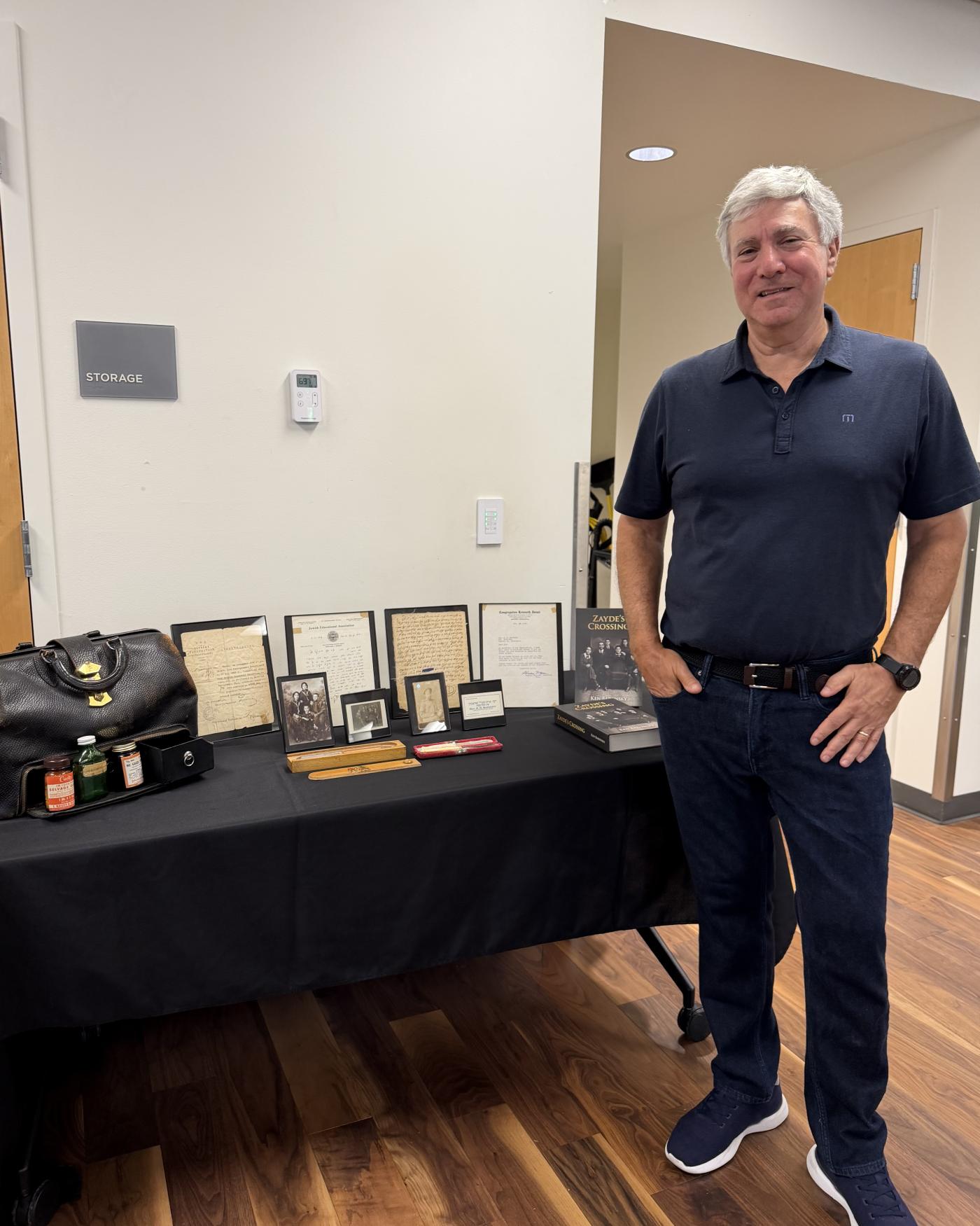 Ken Baronsky standing next to historic items