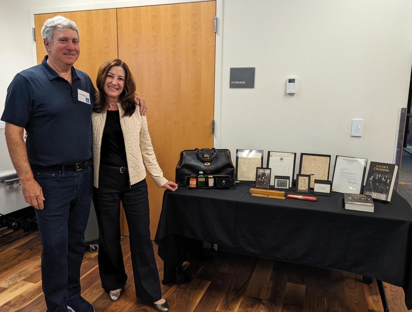 Ken and Lisa Baronsky standing next to historic items