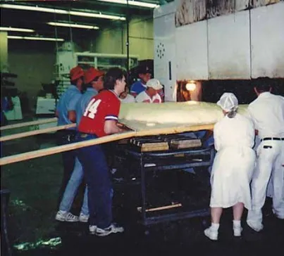 Brenner Brothers bakers easing world's largest bagel into oven, Bellevue, July 1994