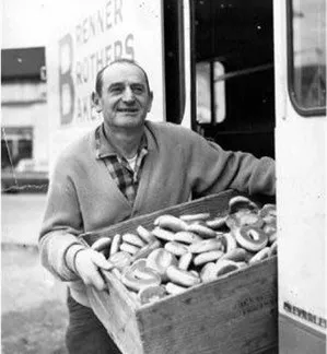 Charlie Brenner holding a box of bagels next to a Brenner Brothers Bakery delivery truck