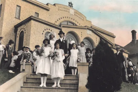 Handwritten on verso: 1924 wedding of Morris and Gentil Israel, Ezra Bessaroth.  Note from donor file: Mr. & Mrs. Sam Benezra, Joe is infant; Isaac Levy sitting (killed WWII); Sera Levy and Bona Israel (Hasson) - bridesmaids; Morris and Gentil Israel - married couple; Hortense Levy Halfon - flower girl, ?, ?, Violet Hasson Israel by tree, Nessim Israel - straw hat, Sam Funes; 9/7/24.