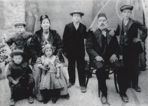 Israel family portrait, in Rhodes, 1915. Left to right: back row: Nissim, Sarah , Sam, Isaac, Morris; front row: John, Bona  Photo Courtesy Samis Foundation