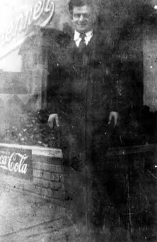 Itsey Brenner standing in front of store