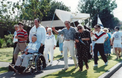 Sefer Torah parade, from Kline Galland Home to Congregation Ezra Bessaroth, August 17, 1991. Left to right: Eddie Hasson, Randy Hasson, Michael Toobert pushing Sam in wheelchair, Bona Hasson, Morrie Capaluto, Jewel Capaluto, Norman Behar, Jerry Cohen.  Photo courtesy Samis Foundation