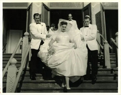 Wedding party descending the front steps of the Bikur Cholim synagogue